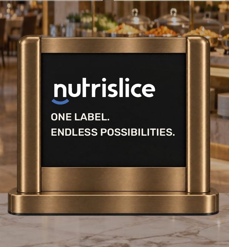 A Nutrislice e-ink label in a brushed-gold frame holder on a buffet, reading one label, endless possibilities